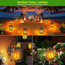 Solar flame lanterns glowing on sand, on a wall bracket and on a garden hook