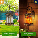 Bronze solar lantern charging on a tree by day and glowing on a wall bracket at night