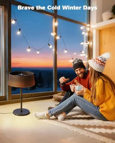 Bronze tabletop patio heater warming a couple beside a winter window