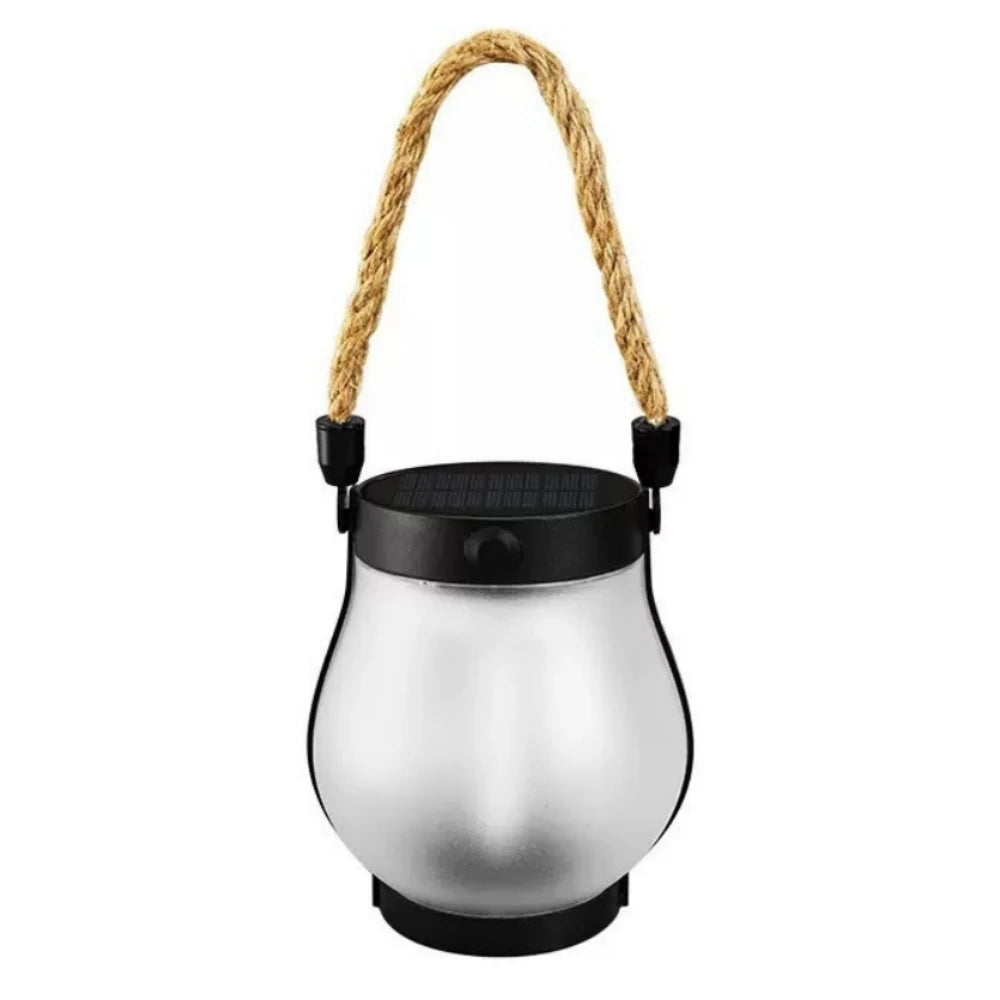 The solar flame lantern unlit on a plain background, showing its frosted shade and rope handle