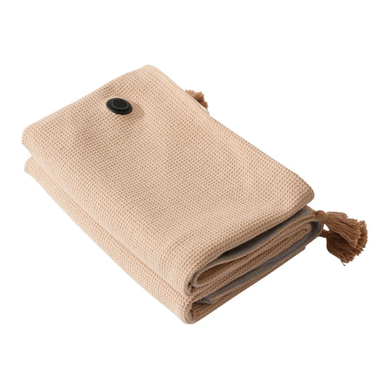 Apricot knitted USB heated shawl blanket folded with tassels