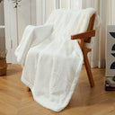 White waffle sherpa heated throw draped over a chair