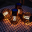 Close view of the hollow-pattern pendant lanterns showing their solar panel tops