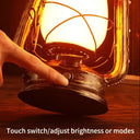 A hand using the lantern's touch switch to adjust brightness and mode