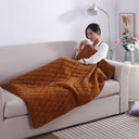 Brown quilted USB heated lap blanket on a sofa
