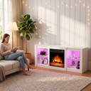 Electric Fireplace TV Stand for TVs up to 65 Inch, 18" Firebox, Modern Media Console Entertainment Center, Adjustable LED Flame for Living Rooms shown in a styled living room with a person relaxing nearby