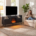 65 Inch Electric Fireplace TV Stand, Modern Media Console Entertainment Center for Living Rooms shown in a styled living room with a person relaxing nearby