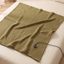 Angled view of the USB Heated Shawl Wrap with Zipper, 3 Temperature Levels, Portable Electric Warming Blanket for Indoor & Outdoor Use in a styled setting