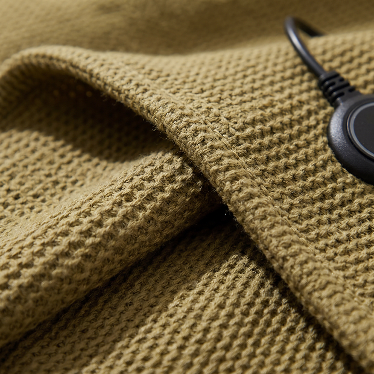 Close-up of the fabric texture and controller on the USB Heated Shawl Wrap with Zipper, 3 Temperature Levels, Portable Electric Warming Blanket for Indoor & Outdoor Use