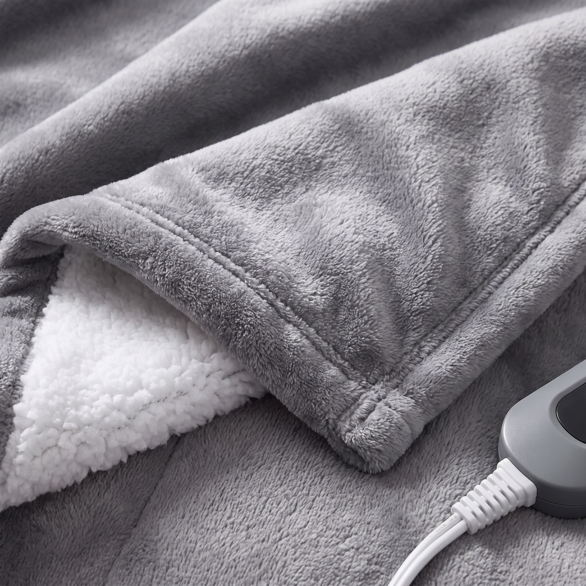 Close-up of the fabric texture and controller on the Electric Heated Throw Blanket, 5 Heat Levels, Soft Flannel Sherpa, Auto Shut-Off and Overheat Protection for Sofa and Bed